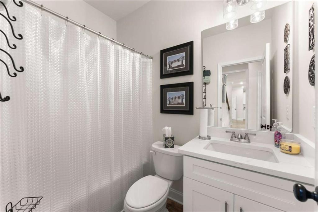 568 Dunagan Court Winder, GA 30680 - Photo 25 of 61 a bathroom with a sink a toilet and shower curtain