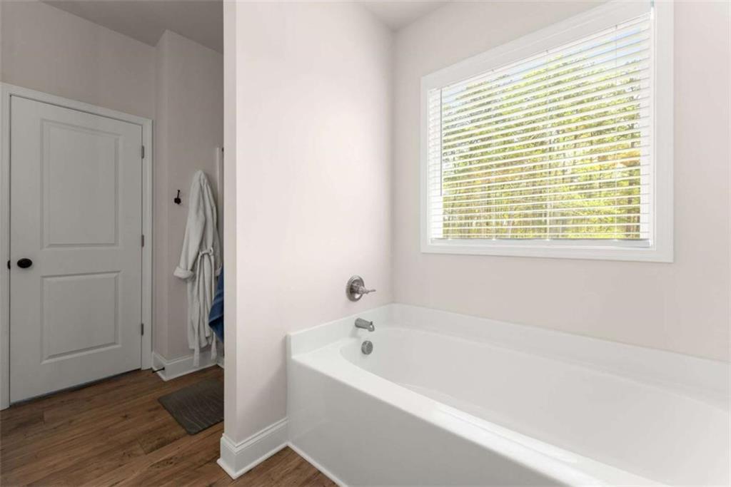 568 Dunagan Court Winder, GA 30680 - Photo 29 of 61 a white bath tub sitting in a bathroom next to a window