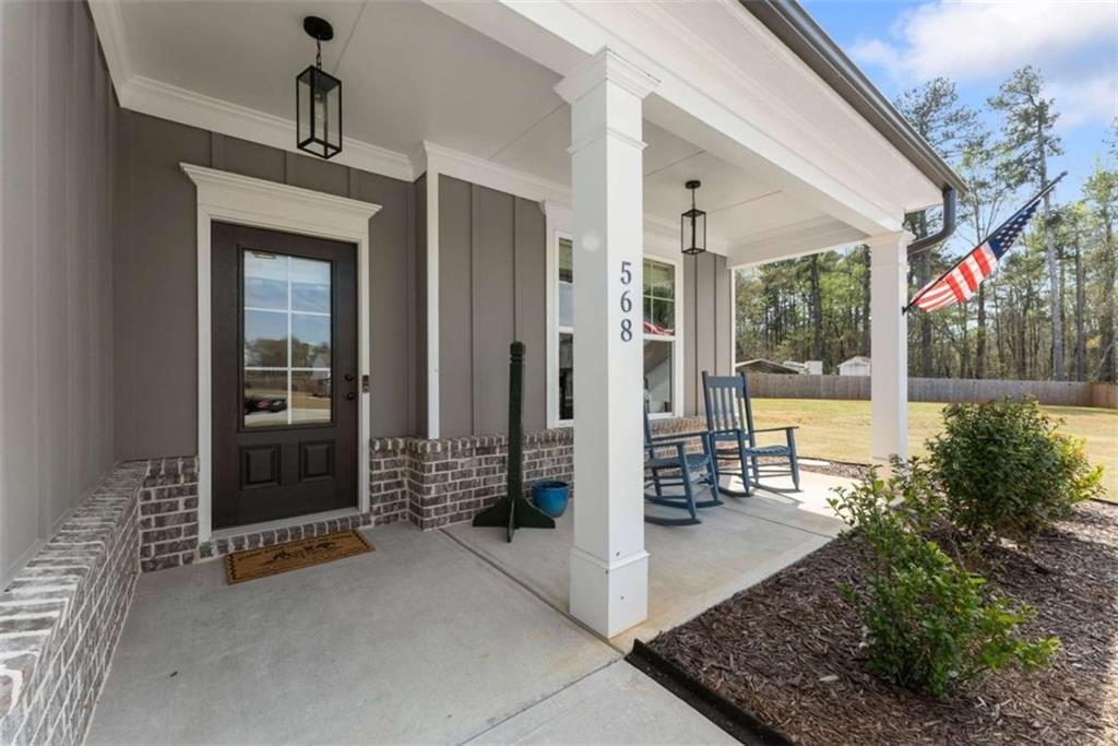 568 Dunagan Court Winder, GA 30680 - Photo 3 of 61 a view of a porch with a table and chairs and potted plants