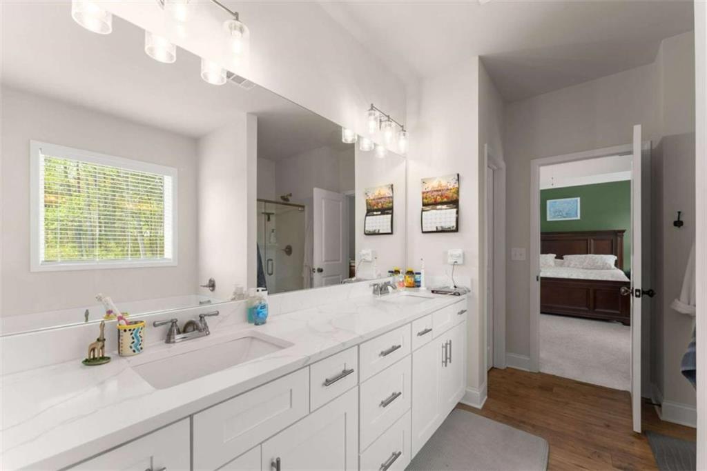 568 Dunagan Court Winder, GA 30680 - Photo 31 of 61 a spacious en suite bathroom with double sink and a mirror