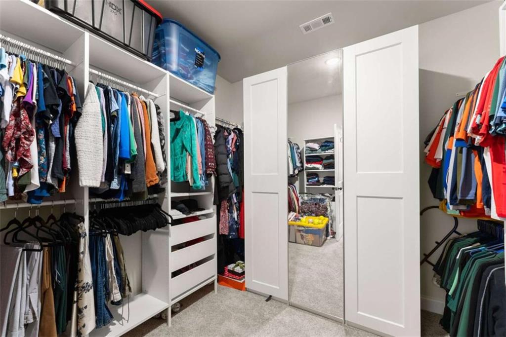568 Dunagan Court Winder, GA 30680 - Photo 33 of 61 a view of walk in closet with clothes and shoes
