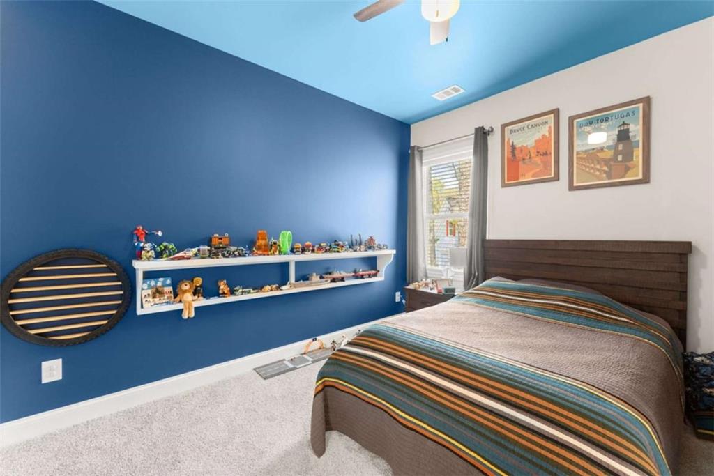 568 Dunagan Court Winder, GA 30680 - Photo 35 of 61 a bedroom with a bed and a chandelier