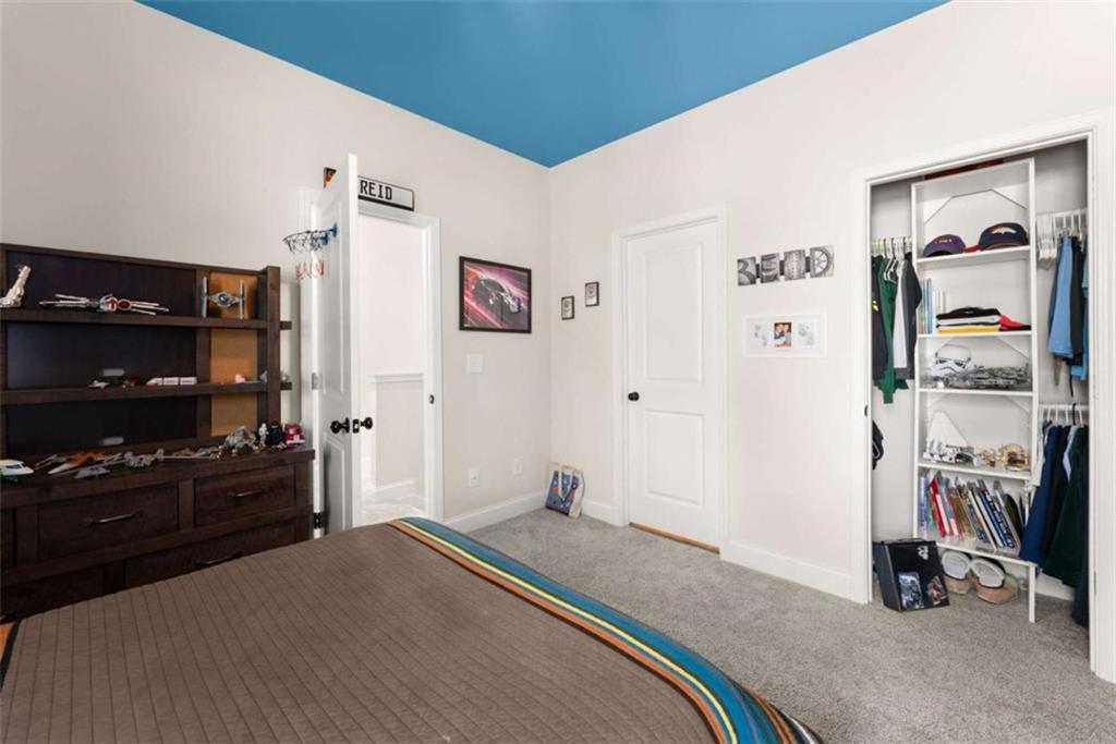 568 Dunagan Court Winder, GA 30680 - Photo 36 of 61 a bedroom with a bed and a flat screen tv