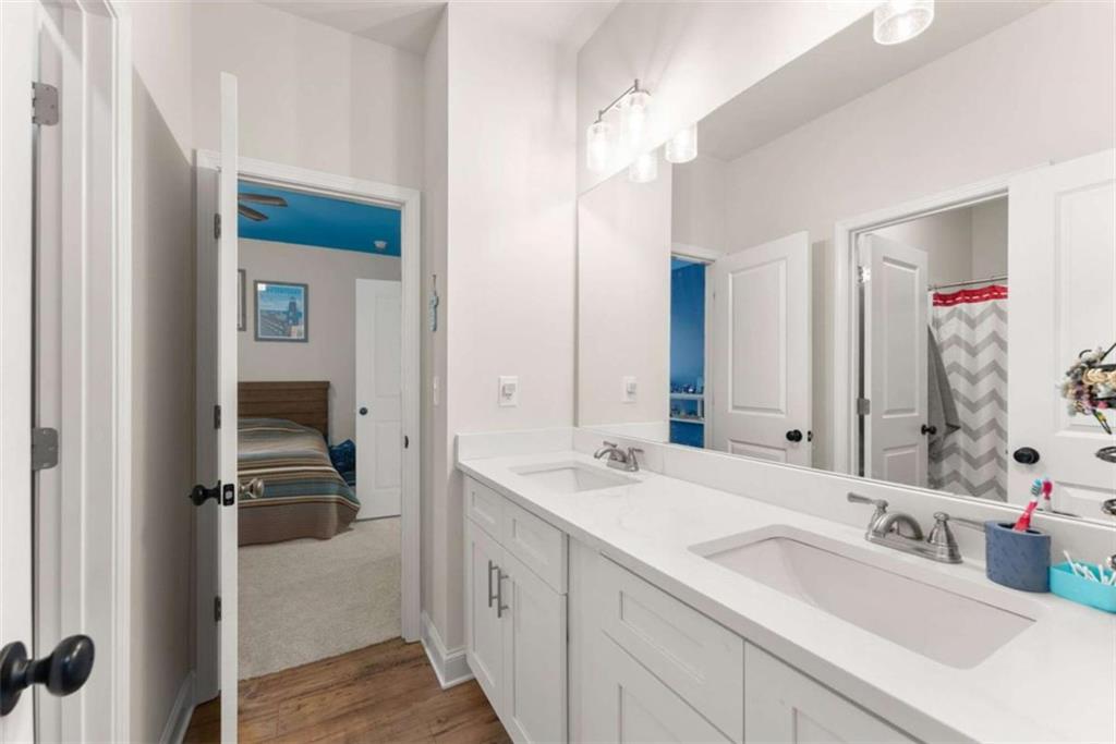 568 Dunagan Court Winder, GA 30680 - Photo 37 of 61 a en suite bathroom with a double vanity sink a mirror and a shower
