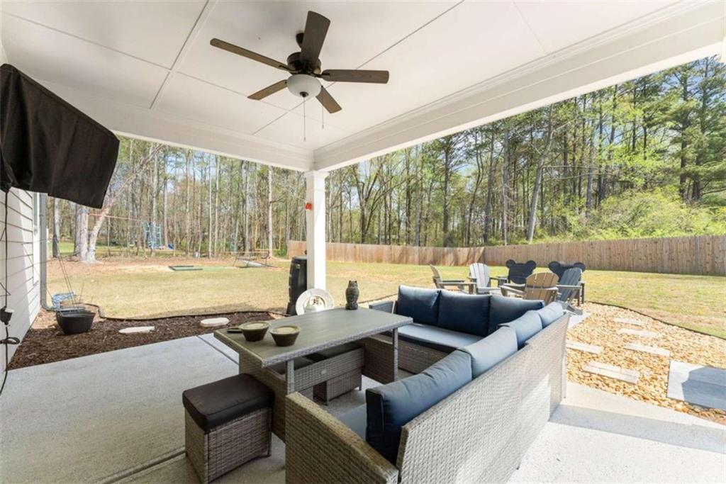568 Dunagan Court Winder, GA 30680 - Photo 44 of 61 a living room with furniture and a flat screen tv