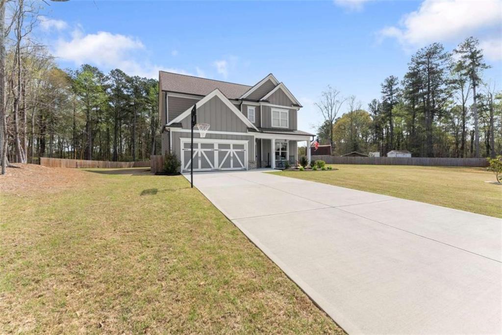 568 Dunagan Court Winder, GA 30680 - Photo 8 of 61 a front view of a house with a yard and trees