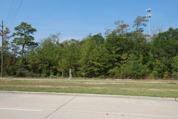 a view of a house in a big yard with large trees
