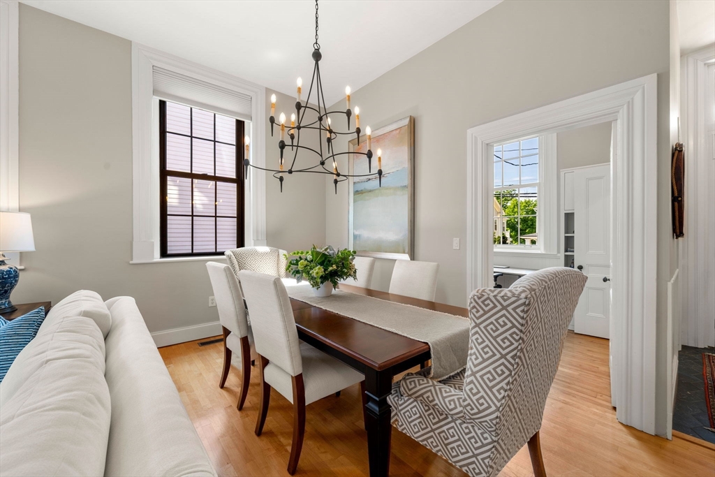 44 Pleasant Street, Unit 1 Marblehead, MA 01945 - Photo 11 of 35 a view of a dining room with furniture wooden floor and chandelier