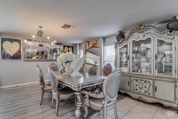 a view of a dining room with furniture and chandelier