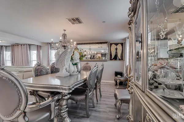 a view of a dining room with furniture and chandelier