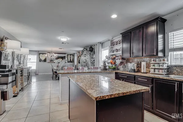 a kitchen with stainless steel appliances granite countertop a sink counter space cabinets and a counter top space