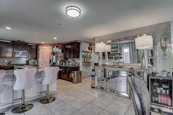 a kitchen with stainless steel appliances kitchen island granite countertop a table and chairs in it