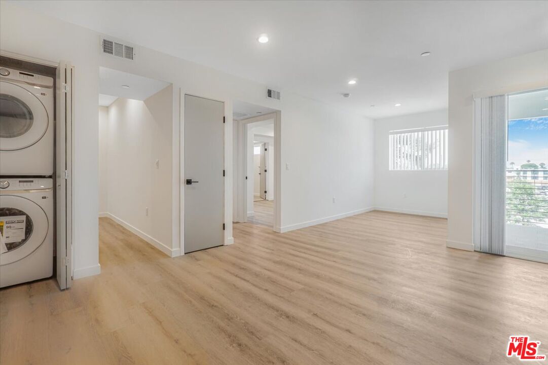 10918 Camarillo Street, Unit 103 North Hollywood, CA 91602 - Photo 13 of 38 a view of a hallway with washer and dryer