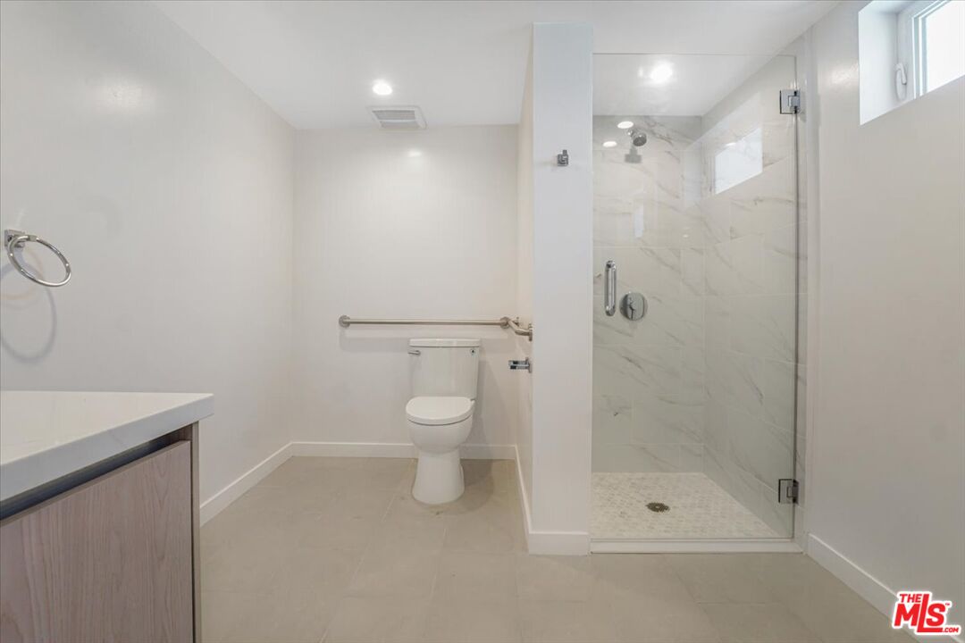 10918 Camarillo Street, Unit 103 North Hollywood, CA 91602 - Photo 20 of 38 a bathroom with a shower and a toilet