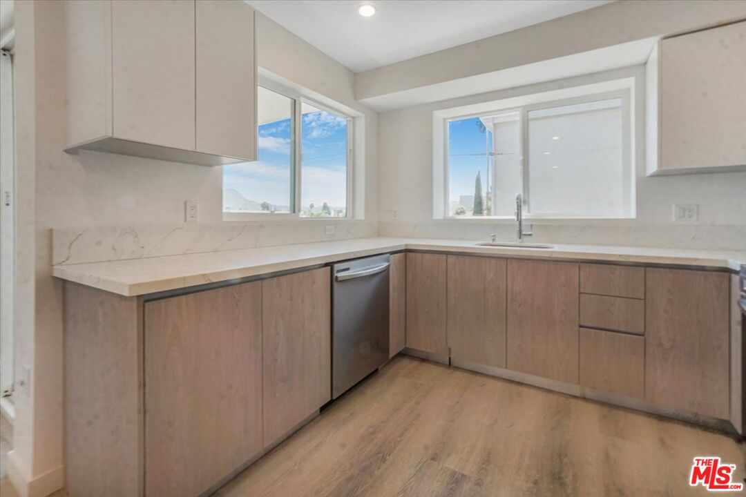 10918 Camarillo Street, Unit 103 North Hollywood, CA 91602 - Photo 32 of 38 a kitchen with a sink cabinets and window
