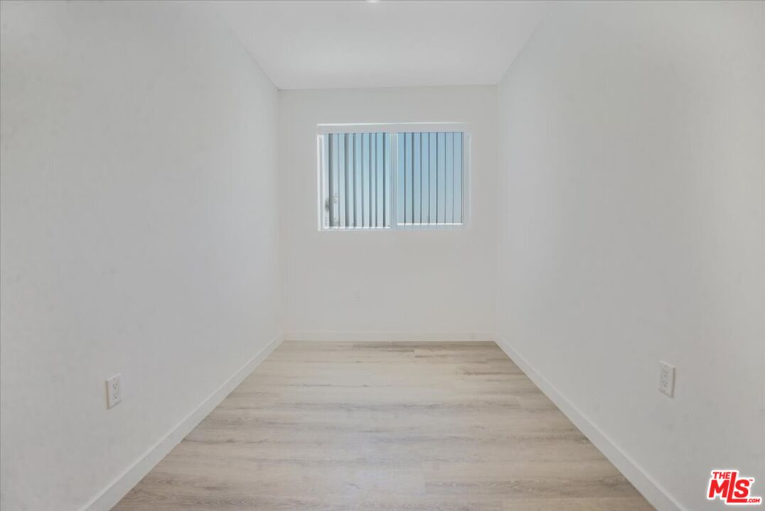 10918 Camarillo Street, Unit 103 North Hollywood, CA 91602 - Photo 5 of 38 a view of an empty room with a window
