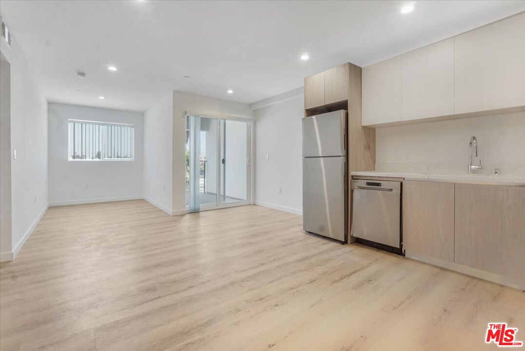10918 Camarillo Street, Unit 103 North Hollywood, CA 91602 - Photo 9 of 38 a view of empty room with wooden floor