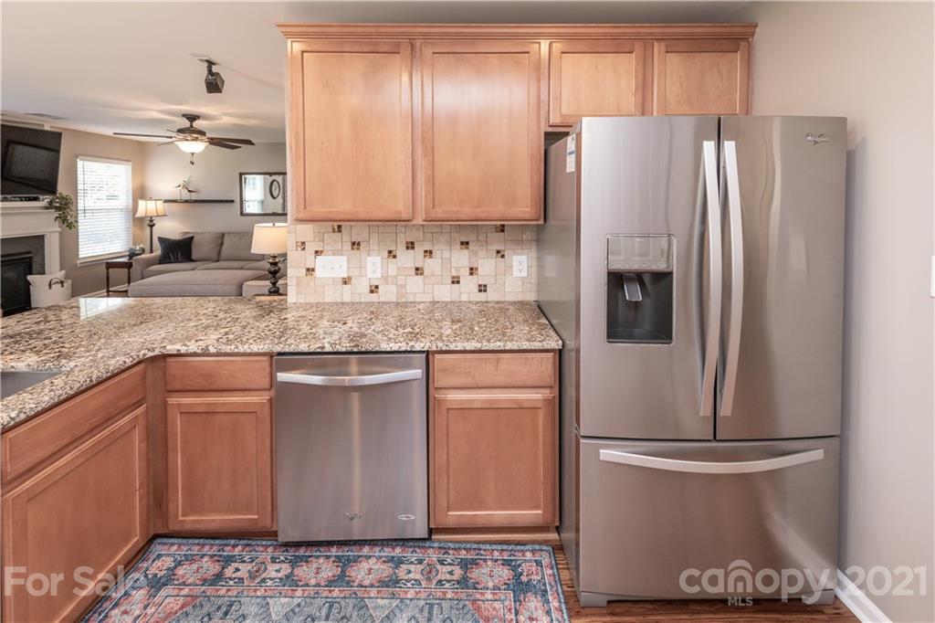 1435 Haverford Road Northwest Concord, NC 28027 - Photo 11 of 31 a kitchen with stainless steel appliances granite countertop a refrigerator a sink and white cabinets
