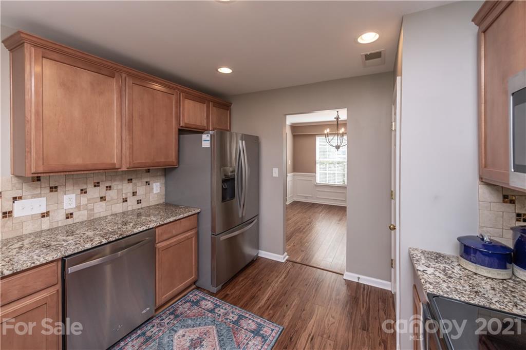 1435 Haverford Road Northwest Concord, NC 28027 - Photo 12 of 31 a kitchen with stainless steel appliances granite countertop a refrigerator sink and cabinets