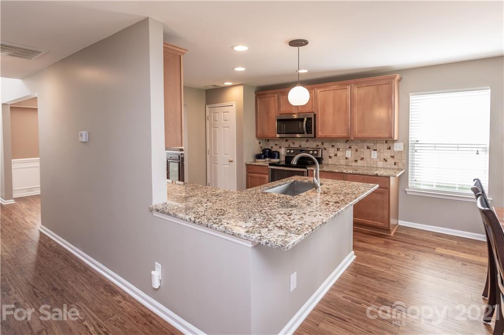 1435 Haverford Road Northwest Concord, NC 28027 - Photo 15 of 31 a kitchen with stainless steel appliances granite countertop a sink stove and refrigerator