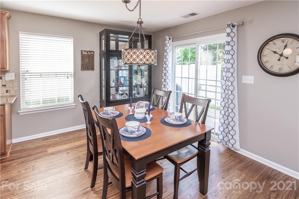 1435 Haverford Road Northwest Concord, NC 28027 - Photo 16 of 31 a view of a dining room with furniture window and wooden floor