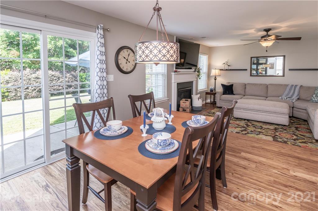 1435 Haverford Road Northwest Concord, NC 28027 - Photo 17 of 31 a view of a dining room with furniture a chandelier and wooden floor