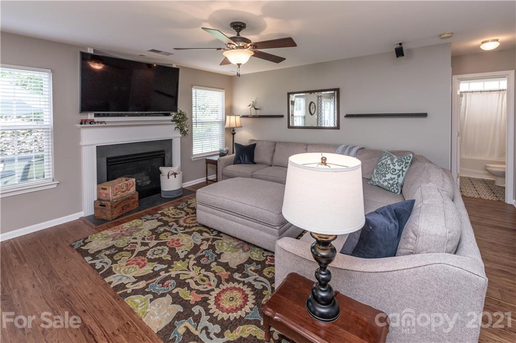 1435 Haverford Road Northwest Concord, NC 28027 - Photo 20 of 31 a living room with furniture a flat screen tv and a fireplace