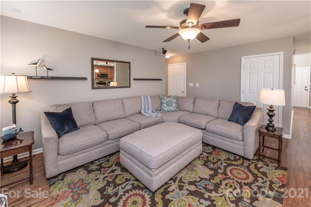 1435 Haverford Road Northwest Concord, NC 28027 - Photo 21 of 31 a living room with furniture a ceiling fan and a rug