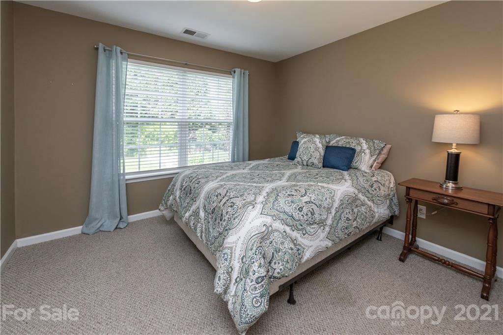 1435 Haverford Road Northwest Concord, NC 28027 - Photo 23 of 31 a bedroom with a bed and a lamp