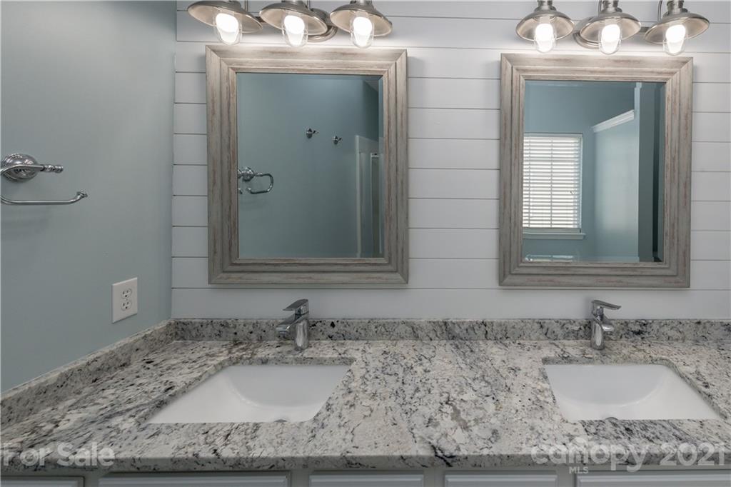 1435 Haverford Road Northwest Concord, NC 28027 - Photo 31 of 31 a bathroom with a granite countertop sink and a mirror
