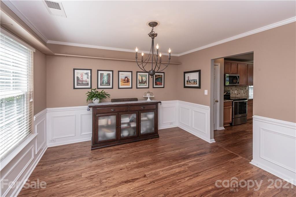 1435 Haverford Road Northwest Concord, NC 28027 - Photo 7 of 31 a living room with furniture and a wooden floor