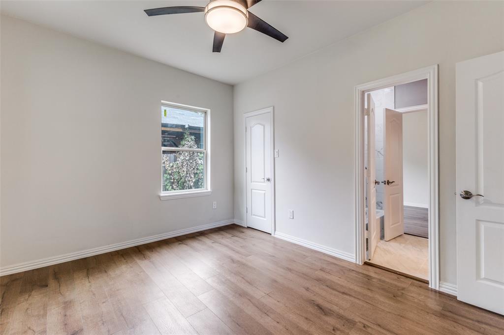 4536 Birch Street Dallas, TX 75223 - Photo 12 of 25 an empty room with wooden floor fan and windows