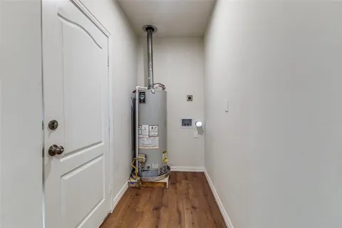 a view of a room with wooden floor and a carpet