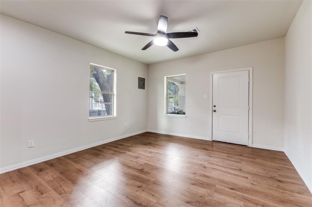 4536 Birch Street Dallas, TX 75223 - Photo 5 of 25 a view of an empty room with wooden floor and a window
