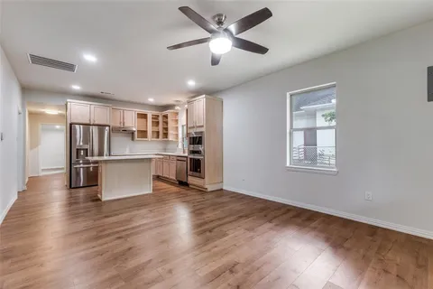 a view of kitchen with refrigerator microwave and wooden floor