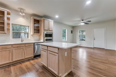 a kitchen with stainless steel appliances granite countertop a sink stove and cabinets