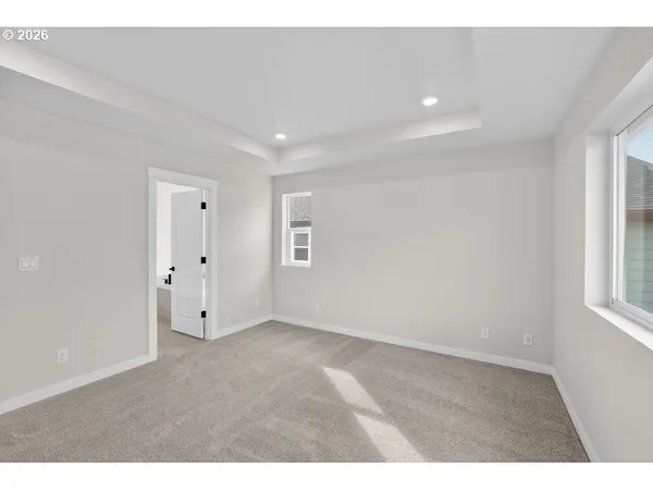 a view of empty room with wooden floor and fireplace