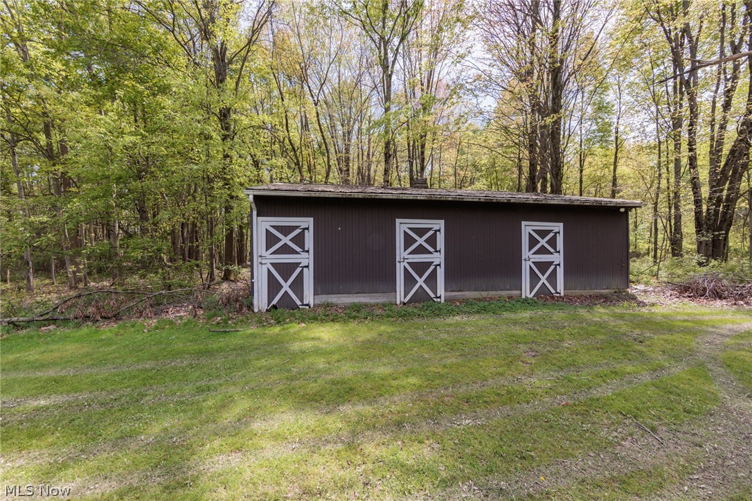 2170 Norton Road Stow, OH 44224 - Photo 19 of 48 Brown corrugated metal outbuilding featuring three white cross-buck doors