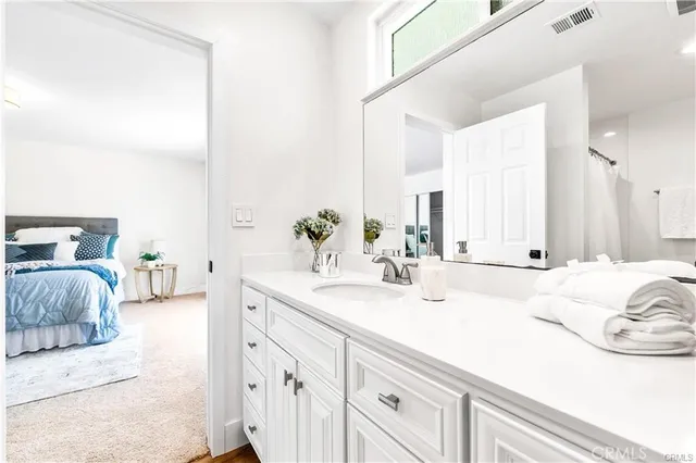 a en suite bathroom with double vanity and a mirror