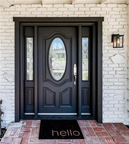 a view of a entryway door with wooden floor