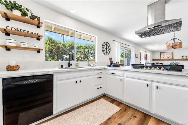 a kitchen with a sink cabinets and window