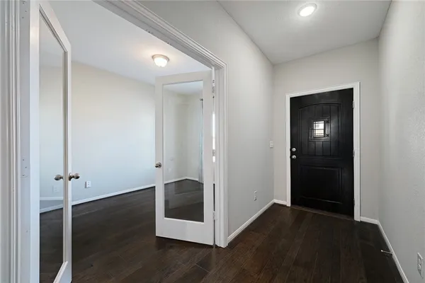 an empty room with wooden floor