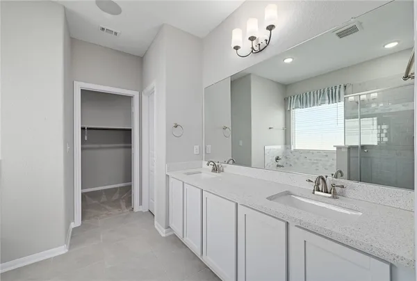 a bathroom with a double vanity sink and a mirror