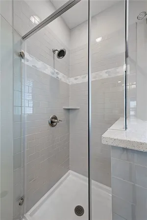 a bathroom with a shower and a mirror