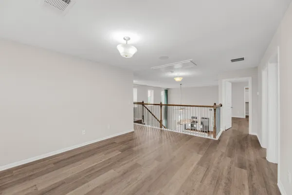 a view of a room with wooden floor