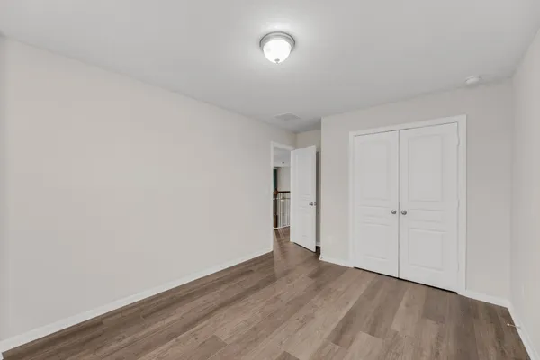 a view of an empty room and wooden floor