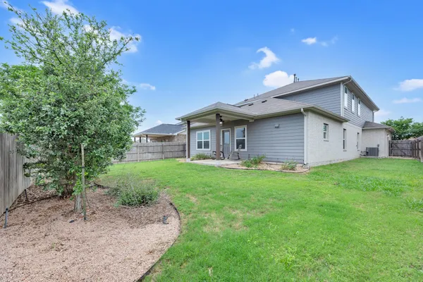 a view of a house with a backyard