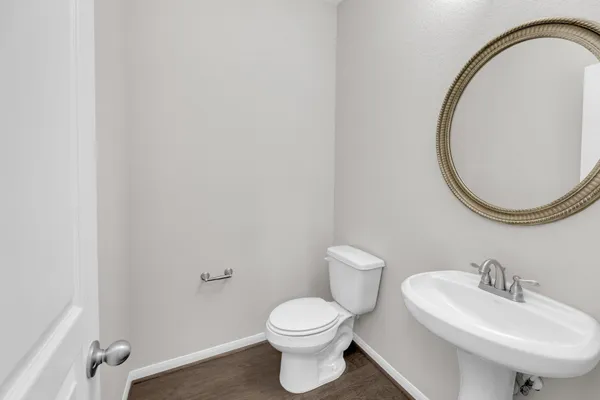 a bathroom with a sink a toilet and a mirror
