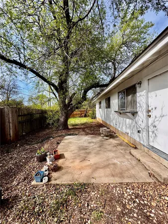 a view of backyard with wheel chair and potted plants