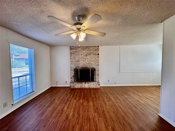 wooden floor in an empty room with a fireplace